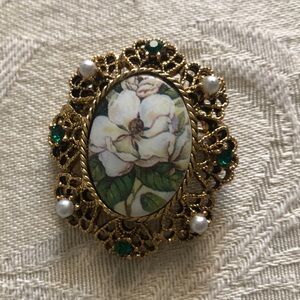 Costume floral brooch with green and white accents